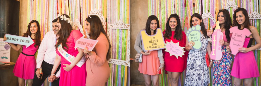 guest posing with customised pla cards at he baby shower